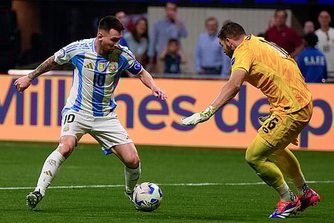 Lionel Messi attempts to dribble past Canada's goalkeeper